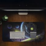 Infidu Space Desk Mat featuring multiple planets and a spacecraft against a deep space background with stars, in shades of blue and green. Desk Pad on the computer table