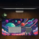 Infidu Space Vector Desk Mat features a colorful space scene with planets, stars, and abstract shapes in bright blues, purples, pinks, and greens. Desk Pad Design Kept on a computer table