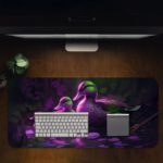 Artistic desk pad with a glowing duck family in purple and green on a dark background with water reflections. Desk Pad Design Kept on a computer table