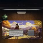 Infidu Artistic Desk Mat with an anime girl on a train platform, autumn trees, mountains, and a blue sky with clouds. Desk Pad in computer table