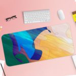 Infidu Artistic Desk Mat with flowing abstract shapes in blue, green, yellow, and orange. Desk Pad with Keyboard and Mouse