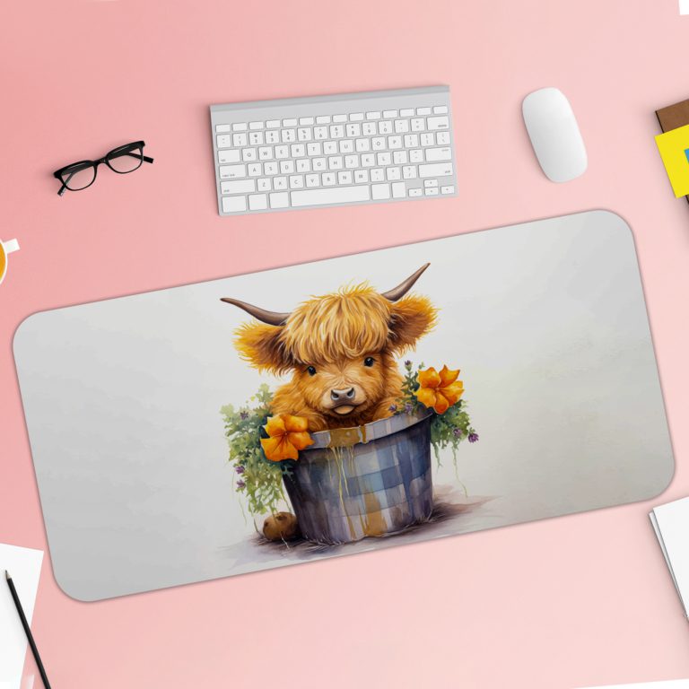 Desk pad with a fluffy brown highland cow sitting in a blue and white bucket, surrounded by yellow flowers and greenery on a light grey background. Desk Pad with Keyboard and Mouse