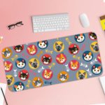 Desk pad with colorful cat faces in circles and playful fish designs on a blue background. Desk Pad with Keyboard and Mouse