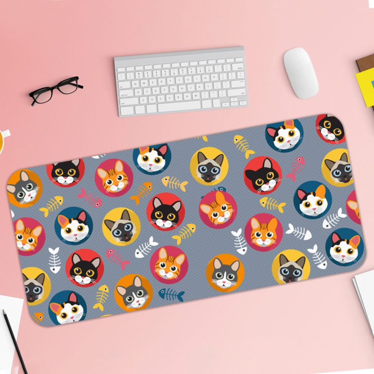 Desk pad with colorful cat faces in circles and playful fish designs on a blue background. Desk Pad with Keyboard and Mouse