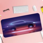 Desk mat showing a futuristic car silhouette with glowing blue, purple, and pink effects on a navy blue background. Desk Pad with Keyboard and Mouse