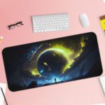 Infidu Space Desk Mat features a large glowing planet or star against a dark space background with swirling yellow-green gases. Desk Pad with Keyboard and Mouse