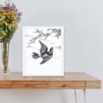 vintage art print of the Hondo Great Spotted Woodpecker by Numata Kashu displayed on the table with white frame.