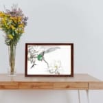 vintage art print featuring the Chinese Tree Pipit and Magnolia by Numata Kashu,brown frame kept on a table