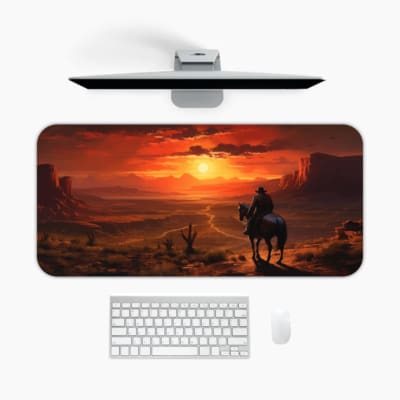 Desert sunset desk pad with a silhouette of a horse rider against a deep orange and red sky, creating a dramatic western scene. A desk pad under the computer