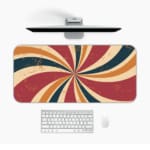 Infidu Flashback Design Desk Pad with a sunburst pattern in red, orange, brown, and blue for a retro, vintage look. Desk Mat with a Computer