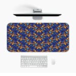 Dark blue desk mat with a dense pattern of small orange and yellow flowers and green leaves, adding vibrant charm to your workspace. Desk Mat with a computer