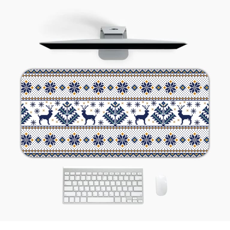 Infidu Desk Pad with white background, featuring blue and yellow reindeer, snowflakes, and geometric shapes in a knitted pattern. Design Kept on a computer table