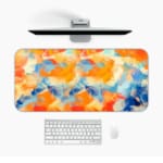 Infidu Desk Pad with an abstract blend of orange, blue, and white, resembling a sunset or colorful sky Desk Pad in computer table.