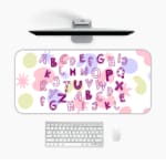 Infidu Alphabet Desk Pad with a white background featuring colorful letters and star shapes in various styles and colors. Desk Pad in computer table