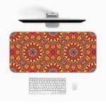 Infidu Desk Pad with bold mandala-like pattern and vibrant red, yellow, and orange details. Desk Mat with a Computer