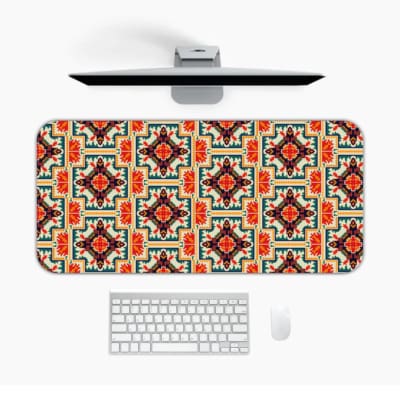 Infidu desk pad with an ornate floral pattern in orange, red, and cream on a light cream background, adding elegance to your workspace. Desk Pad kept on a plain white background