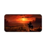 Desert sunset desk pad with a silhouette of a horse rider against a deep orange and red sky, creating a dramatic western scene. Desk Pad kept on a plain white background