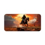 Desk pad with a horse rider against a vivid orange sunset and reddish-brown desert landscape, with dark cliffs and horse in contrasting colors. Desk Pad kept on a plain white background