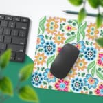 White desk mat with a colorful floral pattern featuring pink, orange, blue, and green flowers, designed for a unique workspace touch. Desk Pad with Keyboard and Mouse