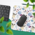 Infidu Painting Style Boho Desk Mat with white background and blue, purple, and brown leaf-like shapes and circles. Desk Pad with Keyboard and Mouse