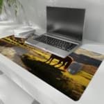 Infidu Horse Rider Desk Pad with a natural landscape showing a person on horseback against mountains, a river, and grassy fields. the desk pad is kept on the laptop