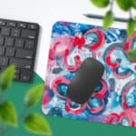 Infidu Desk Pad with vibrant pink and blue swirls, creating an energetic and eye-catching design. Desk Pad with Keyboard and Mouse