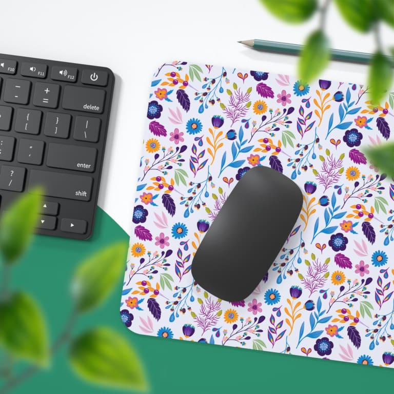 White desk mat with a small, colorful floral pattern featuring purple, pink, and orange flowers with leaves, adding vibrancy to your workspace. Desk Pad with Keyboard and Mouse