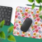 A light pink desk mat with a vibrant floral pattern featuring pink, red, and yellow flowers and blue leaves for a creative workspace touch. Desk Pad with Keyboard and Mouse