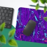 Infidu Vector Pattern Desk Pad with a swirling fluid pattern in purple and light blue on a deep purple background. Desk Pad with Keyboard and Mouse