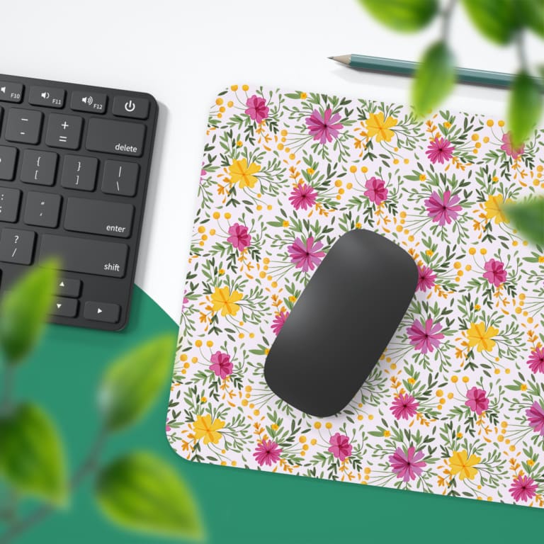 White desk mat with a medium-sized floral pattern in pink, yellow, and purple flowers, adding a vibrant and creative touch to your desk. Desk Pad with Keyboard and Mouse