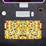 White desk mat with an autumn-themed floral pattern, featuring stylized leaves and flowers in orange, yellow, and green tones. Desk Pad on the computer table