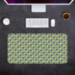 Infidu Geometric Pattern Art Desk Pad with a small, repeating pattern of blue and yellow shapes for a lively and playful look. Desk Pad kept on a gray background