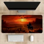 Desert sunset desk pad with a silhouette of a horse rider against a deep orange and red sky, creating a dramatic western scene. desk pad kept on the table