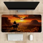 Horse rider in scenic desert sunset with large rock formations and warm sunset colors on a desk pad. desk pad kept on the table