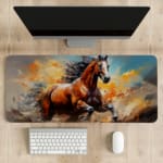 Majestic horse galloping with flowing mane and tail on a colorful abstract background of oranges and blues. desk pad kept on the table