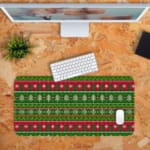 Infidu Knitted Pattern Desk Pad with green background, Christmas trees, snowflakes, and red stripes for a festive holiday feel. Desk Pad kept on a orange background