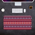 Infidu Desk Pad with a red background, featuring pink, white, and black Christmas trees, reindeer, and snowflakes in a knitted pattern. Desk Pad with Keyboard and Mouse in gray background