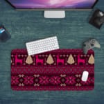 Infidu Desk Pad with a deep purple background and bright pink and white knitted pattern featuring reindeer and trees. Desk Pad kept on a green background