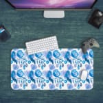 Infidu Desk Pad with blue raindrop or leaf-like brush stroke patterns on a white background, creating a calm and refreshing design. Desk Pad kept on a green background