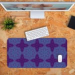 Infidu Desk Pad with a deep purple background and light blue floral or snowflake pattern, adding elegance and style to your workspace. Desk Pad with Keyboard and Mouse in orange background