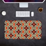 Infidu desk pad with an ornate floral pattern in orange, red, and cream on a light cream background, adding elegance to your workspace. Desk Pad kept on a gray background