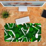 Infidu Desk Pad features green geometric patterns on a dark background, adding a stylish and durable touch to any workspace. Desk Pad with Keyboard and Mouse in orange background