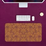 Infidu Vector Pattern Desk Pad with maze-like design in light brown on a solid light brown background. Desk Pad with Keyboard and Mouse in pink background