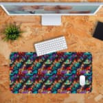 Infidu Vector Pattern Desk Pad with an abstract, chaotic pattern in reds, blues, greens, and yellows against a dark background. Desk Pad with Keyboard and Mouse in orange background