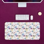 Infidu Painting Style Boho Desk Mat with white background and blue, purple, and brown leaf-like shapes and circles. Desk Pad with Keyboard and Mouse in pink background