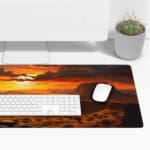 Horse rider in scenic desert sunset with large rock formations and warm sunset colors on a desk pad. Desk Pad with Keyboard and Mouse on top of the desk pad