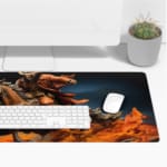 Dynamic desk pad featuring a fiery horse rider in action with vivid flames and a dark background. Desk Pad with Keyboard and Mouse on top of the desk pad