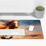 Dynamic brown horse galloping with flowing mane against a blue sky background. Desk Pad with Keyboard and Mouse on top of the desk pad