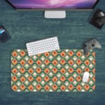 Infidu Geometric Pattern Art Desk Pad with a retro diamond-shaped pattern in orange and teal for a stylish and symmetrical workspace. Desk Pad kept on a green background