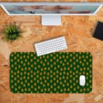 Infidu Desk Pad with dark green background and light green dots resembling leaves or flower buds, adding a natural touch to your workspace. Desk Pad kept on a orange background